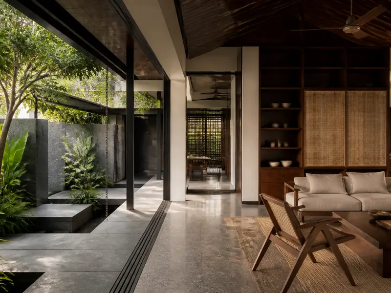 Tropical Singapore home where architectural structure and a warm, carefully planned interior meet a planted courtyard.