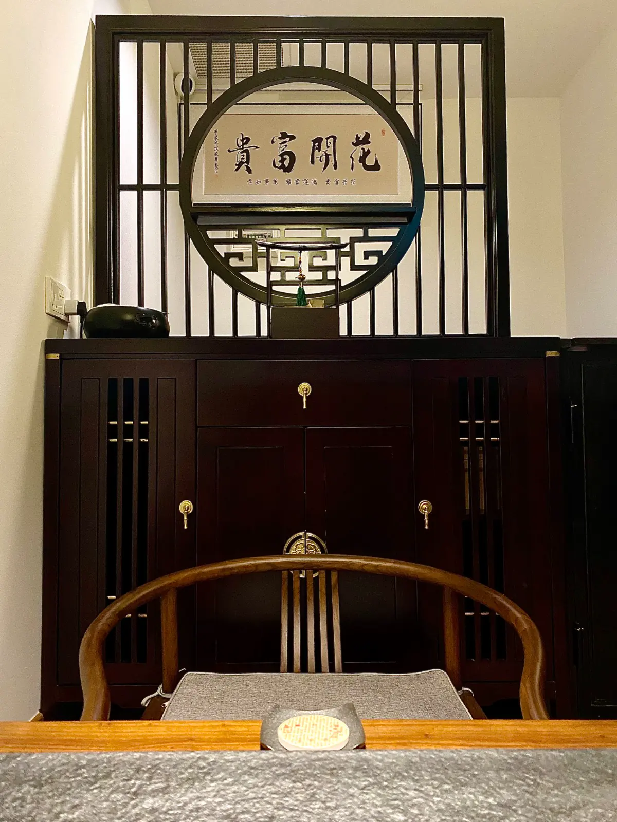 A horseshoe-back chair set against classical cabinetry