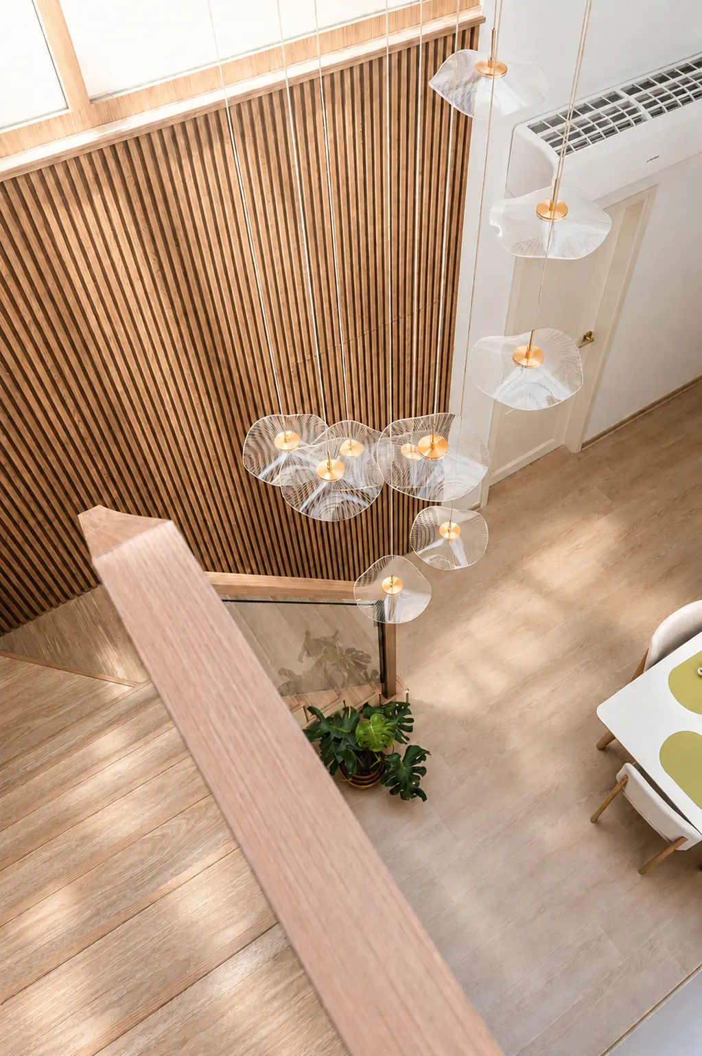 The double-volume void above the dining area, with its sculptural cluster of pendants