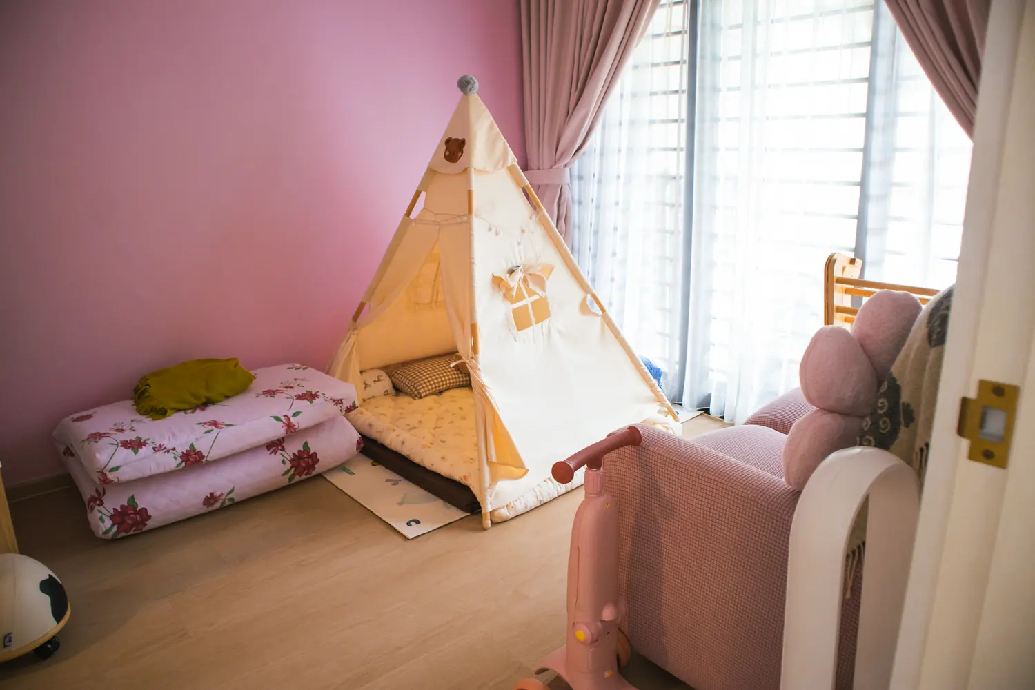 The children's room, pale timber flooring against a soft pink wall