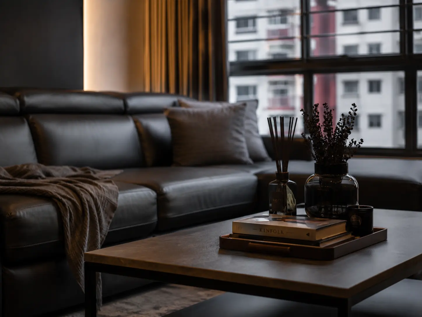 Charcoal leather seating at the window, city light behind